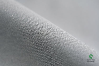 Close-up of the grey woven fabric on the Grounding Half Sheet, showing the fine silver conductive threads running through the weave.