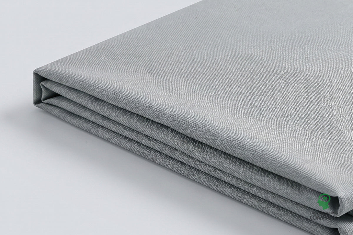 The Grounding Half Sheet folded into a compact stack, showing its grey woven texture and finished edge.