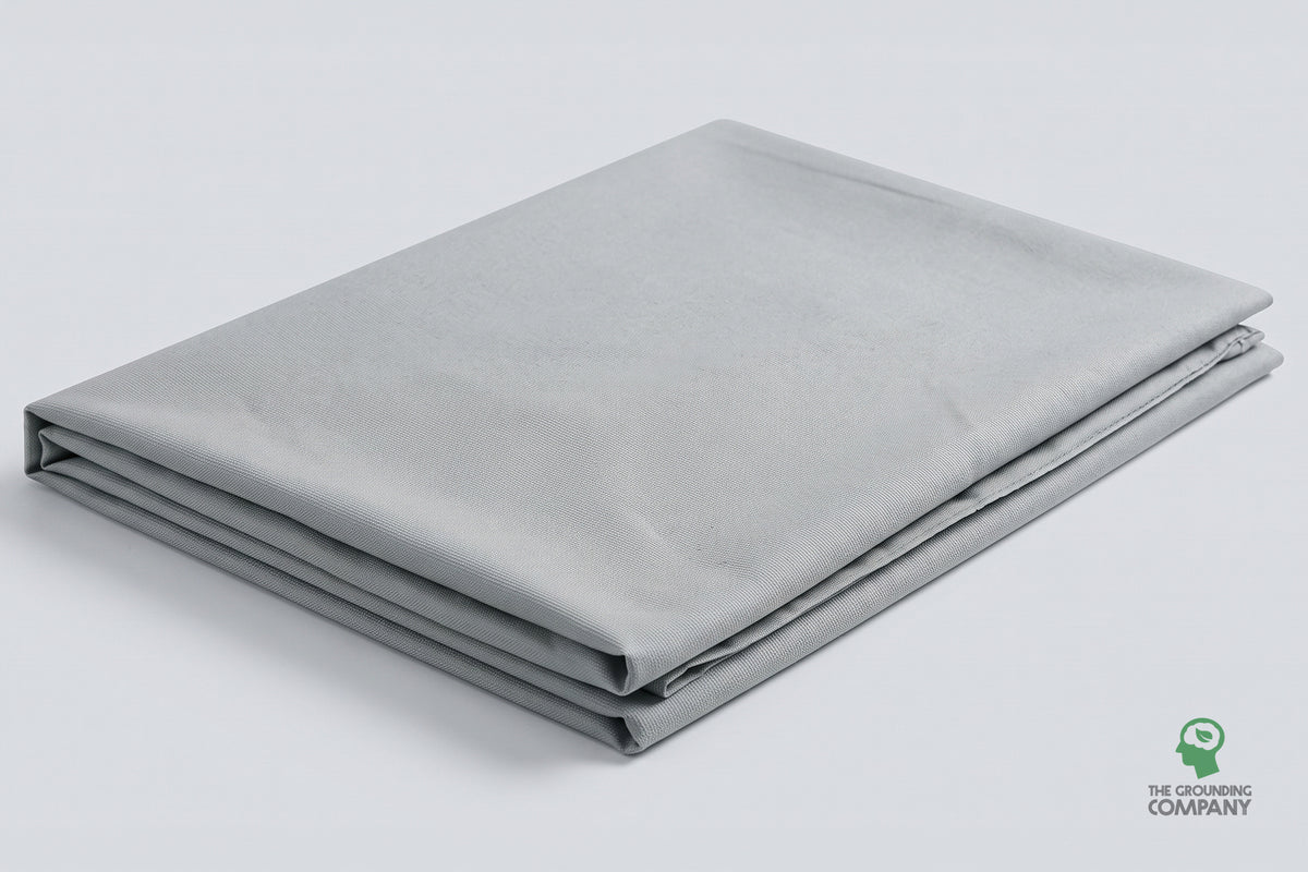 The grey Grounding Half Sheet folded and laid flat against a plain studio background, showing its full size and finish.