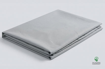 The grey Grounding Half Sheet folded and laid flat against a plain studio background, showing its full size and finish.