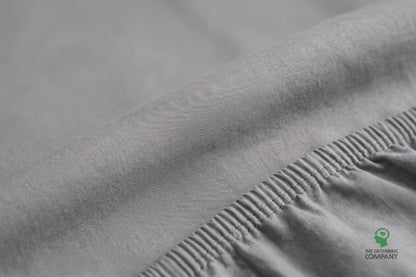 Close-up of the fitted sheet's top panel and elasticated cotton side seam