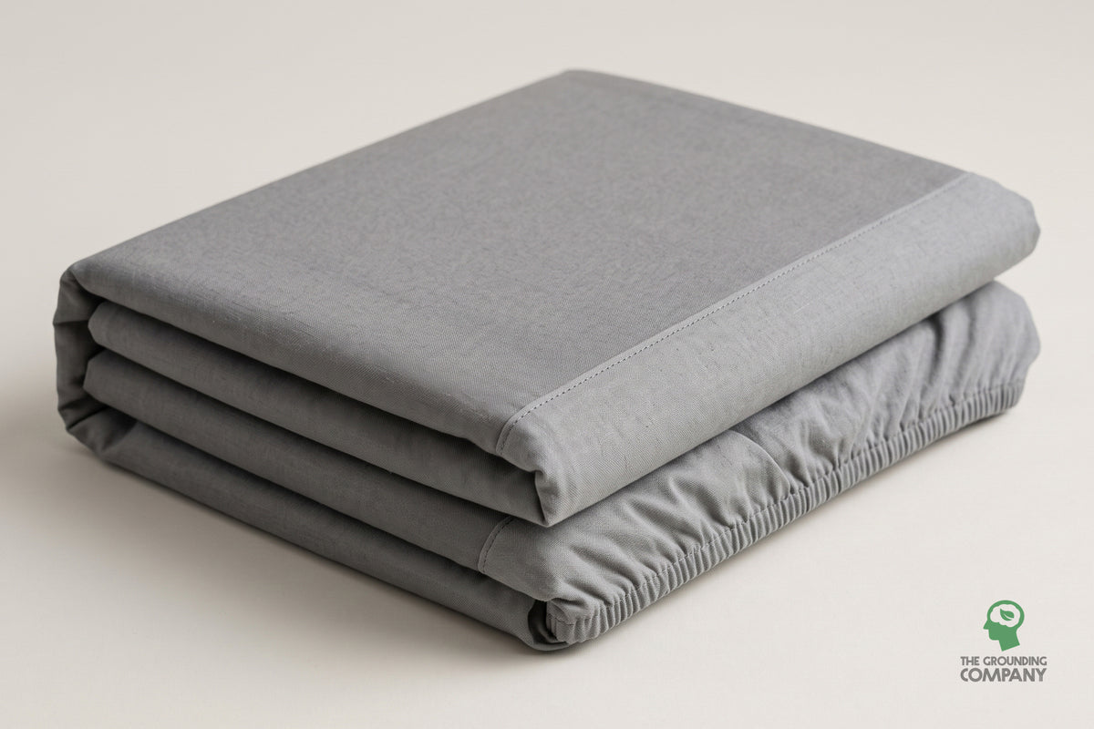 Folded fitted sheet showing the grey top panel and stitched cotton side panel