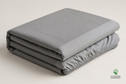 Folded fitted sheet showing the grey top panel and stitched cotton side panel