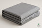 Folded fitted sheet showing the grey top panel and stitched cotton side panel