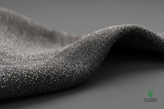 Macro view of silver-coated fabric folded to show its metallic sheen