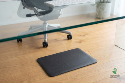 Grounding PU Foot Mat on the floor beside an office chair and glass desk