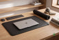 Grounding Desk & Standing Mat on a wooden desk with a laptop, keyboard, and mouse resting on it